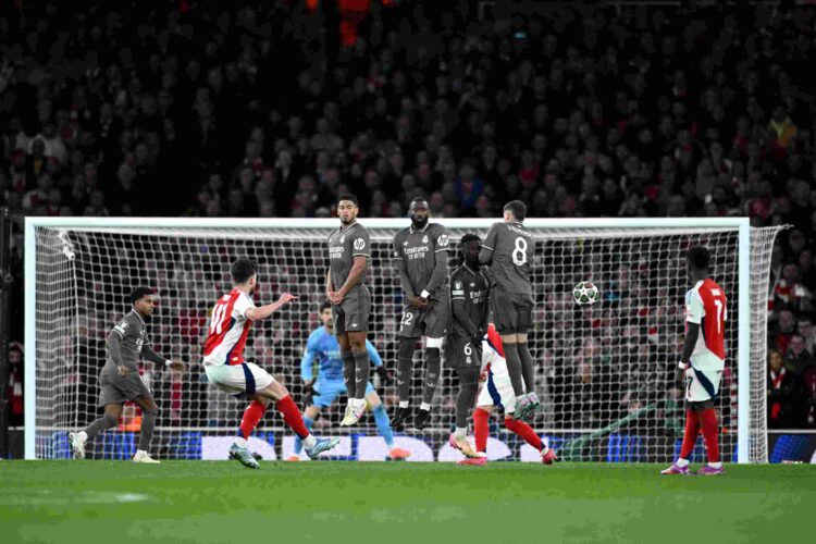 Declan Rice of Arsenal scores his team's first goal from a free kick as Jude Bellingham, Antonio Ruediger, Eduardo Camavinga and Federico Valverde ...
