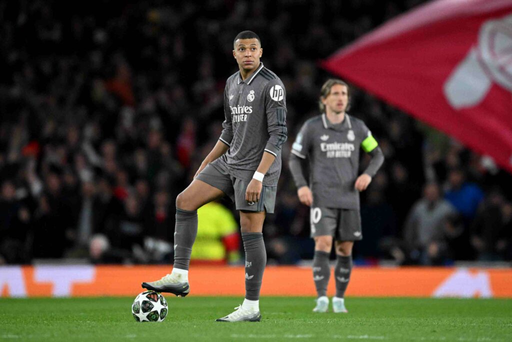Kylian Mbappe of Real Madrid looks on as he prepares to restart play after Declan Rice of Arsenal (not pictured) scores his team's first goal durin...