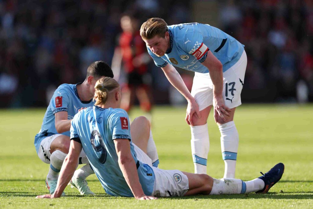 Rival watch: Erling Haaland season all but over over in blow to City's top-four hopes 2 BOURNEMOUTH, ENGLAND - MARCH 30: Kevin De Bruyne and Phil Foden (obscured) of Manchester City interact team mate Erling Haaland after he sustains an injury during the Emirates FA Cup Quarter Final match between AFC Bournemouth and Manchester City at Vitality Stadium on March 30, 2025 in Bournemouth, England. (Photo by Alex Pantling/Getty Images)