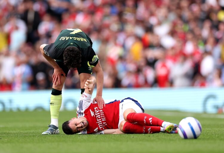 LONDON, ENGLAND: Gabriel Martinelli of Arsenal reacts as he is consoled by Christian Norgaard of Brentford after going down with an injury during t...