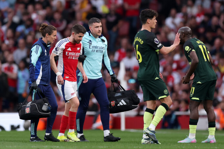 LONDON, ENGLAND - APRIL 12: Jorginho of Arsenal is assisted off the pitch by Simon Murphy, Physio of Arsenal, after going down with an injury durin...