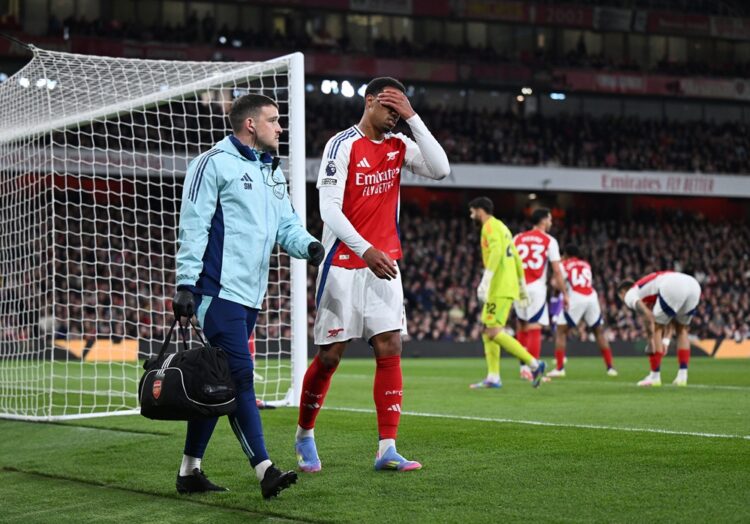 LONDON, ENGLAND: Gabriel of Arsenal looks dejected as he leaves the pitch with a member of the medical team after picking up an injury during the P...
