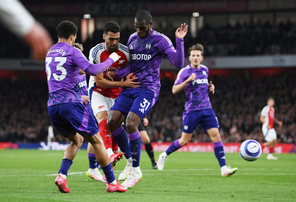 LONDON, ENGLAND - APRIL 01: Mikel Merino of Arsenal scores his team's first goal whilst under pressure from Issa Diop (R) and Antonee Robinson (L) of Fulham during the Premier League match between Arsenal FC and Fulham FC at Emirates Stadium on April 01, 2025 in London, England. (Photo by Justin Setterfield/Getty Images)