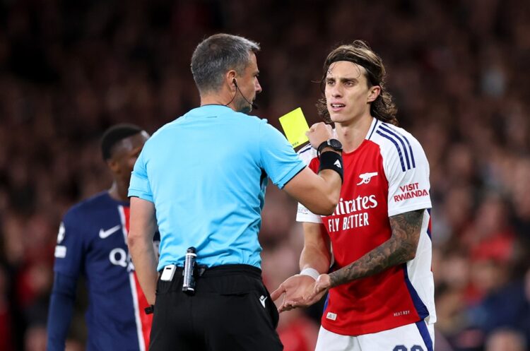 LONDON, ENGLAND: Riccardo Calafiori of Arsenal is shown a yellow card by Match Referee Slavko Vincic during the UEFA Champions League 2024/25 Leagu...