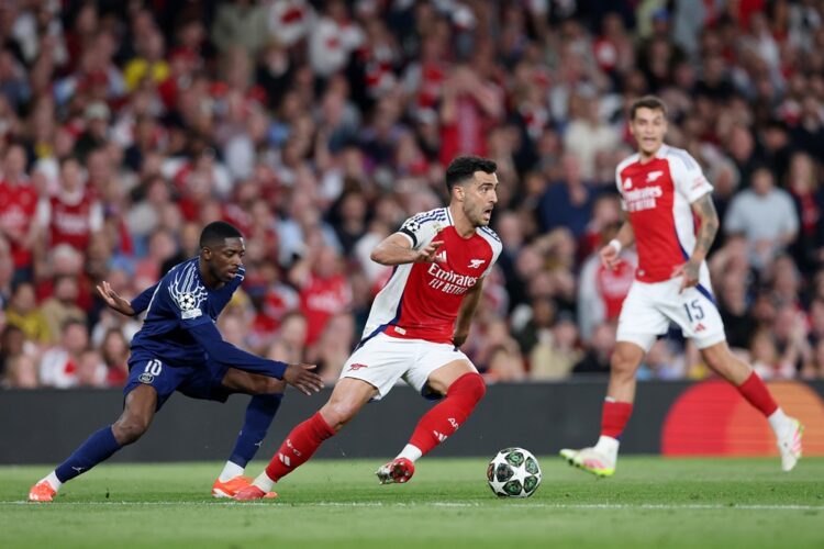 LONDON, ENGLAND: Mikel Merino of Arsenal runs with the ball whilst under pressure from Ousmane Dembele of Paris Saint-Germain during the UEFA Champ...