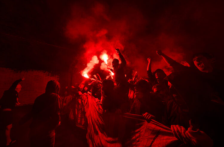 LONDON, ENGLAND - APRIL 08: The Ashburton Army set off flares in a tunnel on their way to the stadium during the UEFA Champions League 2024/25 Quar...