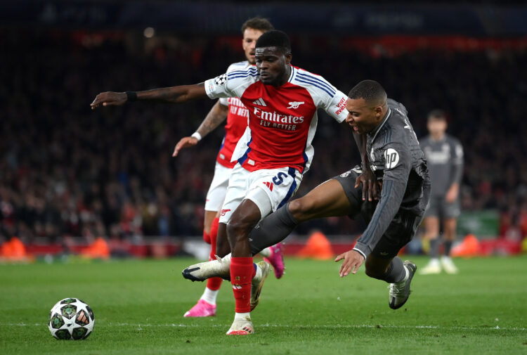 LONDON, ENGLAND - APRIL 08: Kylian Mbappe of Real Madrid is tackled by Thomas Partey of Arsenal during the UEFA Champions League 2024/25 Quarter Fi...