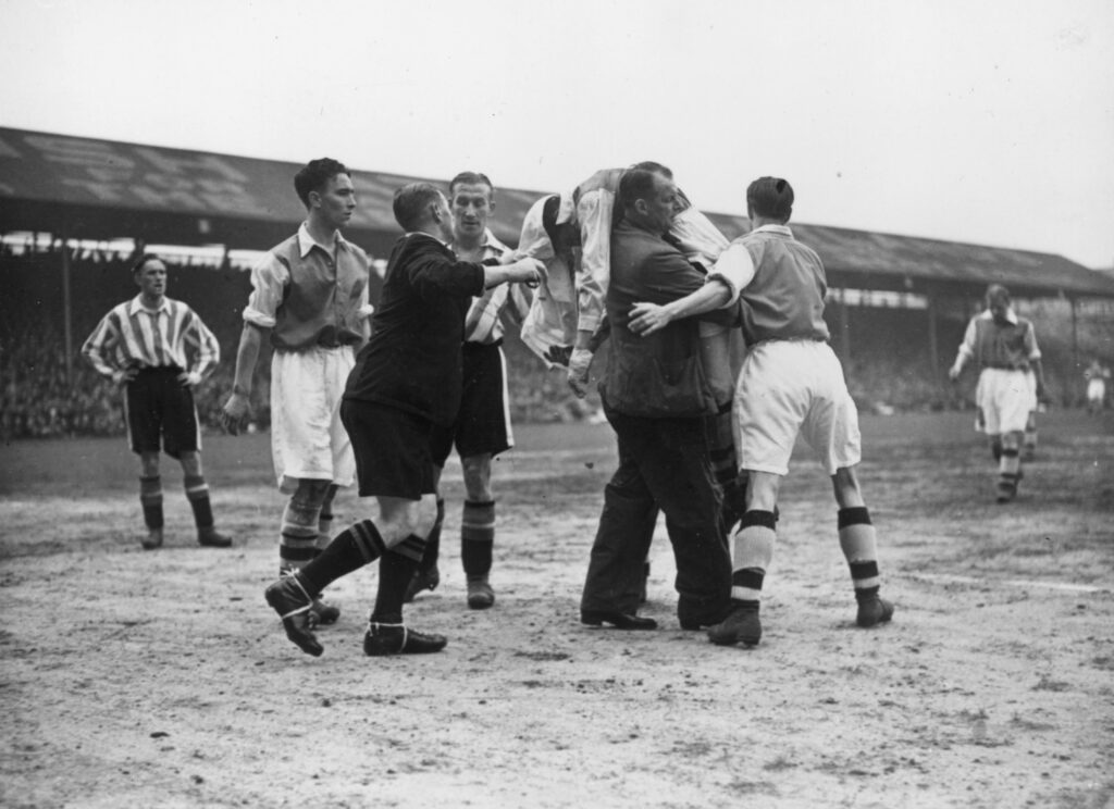 3 Brentford players injured for Arsenal trip, 2 doubts 5 18th April 1938: Ted Drake, the Arsenal centre-forward, is carried off the field by the Arsenal trainer after being knocked unconscious during a match between Brentford and Arsenal at Griffin Park, Brentford. (Photo by David Savill/Topical Press Agency/Getty Images)