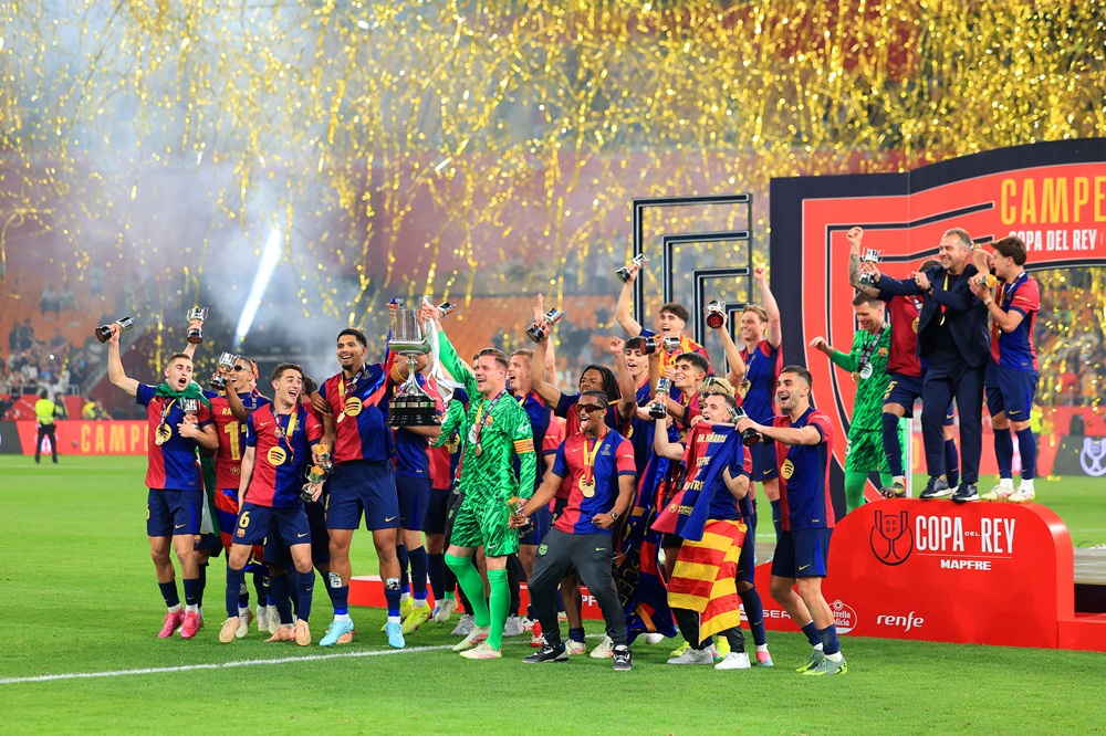 SEVILLE, SPAIN: Ronald Araujo and Marc-Andre ter Stegen of FC Barcelona lift the Copa del Rey trophy after the team's victory in the Copa del Rey F...