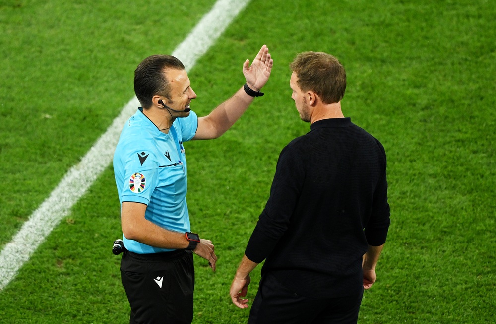 Arsenal learn referee for Real Madrid clash 3 DORTMUND, GERMANY: Julian Nagelsmann, Head Coach of Germany, speaks to Fourth Official Irfan Peljto as play is suspended due to a thunderstorm during the UEFA EURO 2024 round of 16 match between Germany and Denmark at Football Stadium Dortmund on June 29, 2024. (Photo by Clive Mason/Getty Images)