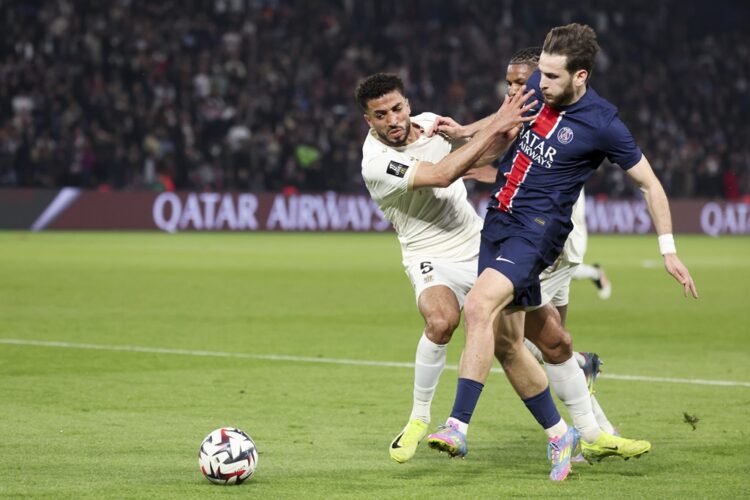 PARIS, FRANCE: Mohamed Abdelmoneim Ahmed of OGC Nice challenges Khvicha Kvaratskhelia of Paris Saint-Germain during the Ligue 1 match between Paris...