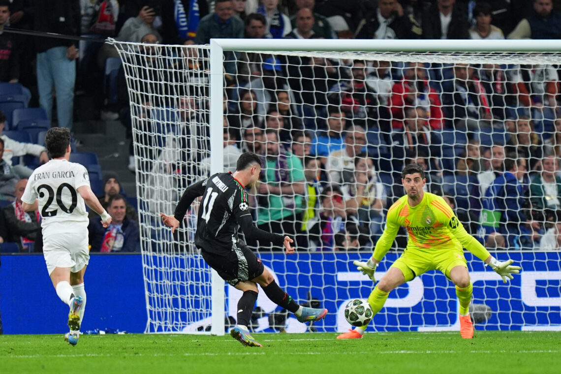 MADRID, SPAIN - APRIL 16: Gabriel Martinelli of Arsenal scores his team's second goal past Thibaut Courtois of Real Madrid during the UEFA Champion...