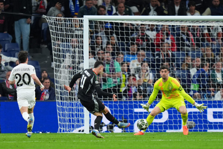 MADRID, SPAIN - APRIL 16: Gabriel Martinelli of Arsenal scores his team's second goal past Thibaut Courtois of Real Madrid during the UEFA Champion...