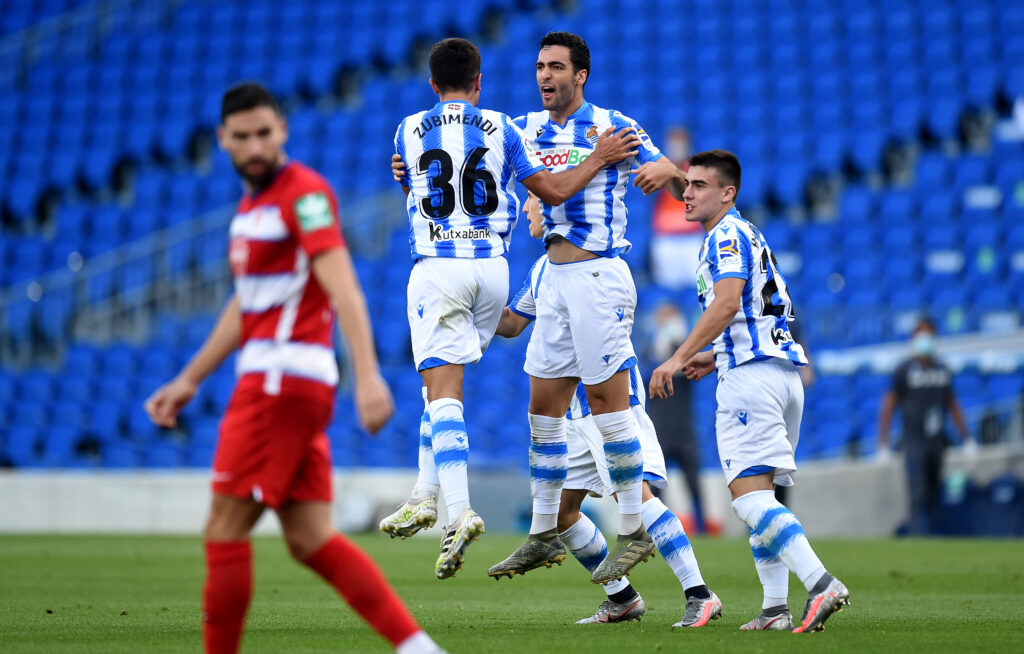SAN SEBASTIAN, SPAIN - JULY 10: Mikel Merino of Real Sociedad is congratulated by Martin Zubimendi of Real Sociedad after he scores his teams first goal during the Liga match between Real Sociedad and Granada CF at Estadio Anoeta on July 10, 2020 in San Sebastian, Spain. (Photo by Juan Manuel Serrano Arce/Getty Images)