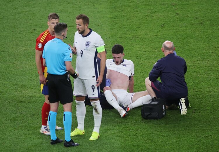 BERLIN, GERMANY: Referee Francois Letexier speaks with Harry Kane of England as Declan Rice of England receives medical treatment during the UEFA E...