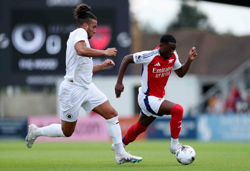 Released Arsenal forward signs 3-year deal with new club 2 Khayon Edwards of Arsenal XI runs with the ball whilst under pressure from Chris Bush of Boreham Wood during the Pre-Season Friendly match between ...