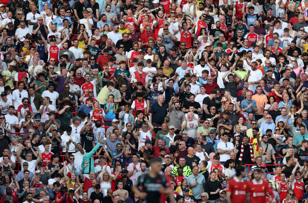 Arsenal fans celebrate after Gabriel Martinelli of Arsenal (not pictured) scored the team's first goal during the Premier League match between Live...