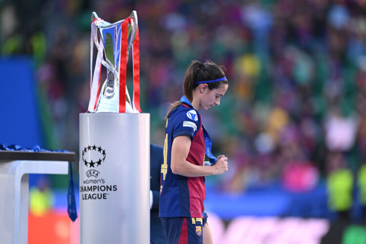 LISBON, PORTUGAL - MAY 24: Aitana Bonmati of FC Barcelona walks past the UEFA Women's Champions League trophy, while looking at her runners up meda...