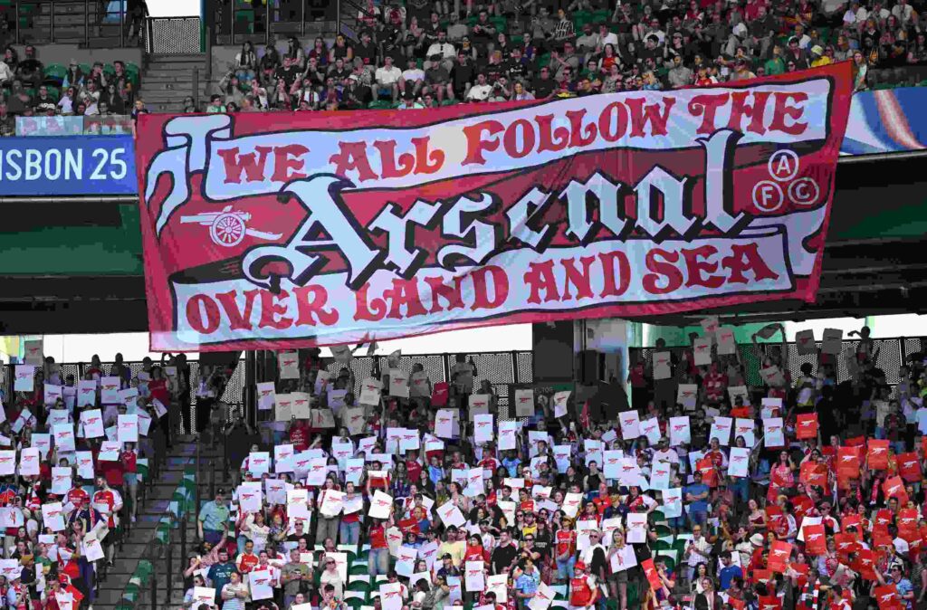 LISBON, PORTUGAL - MAY 24: Fans of Arsenal display a banner which reads "We all follow the Arsenal over land and sea" prior to the UEFA Women's Champions League final match between Arsenal WFC and FC Barcelona at Estadio Jose Alvalade on May 24, 2025 in Lisbon, Portugal. (Photo by David Ramos/Getty Images)
