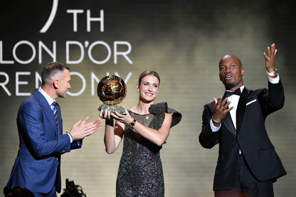 PARIS, FRANCE - OCTOBER 17: Alexia Putellas (C) receives her second Woman Ballon d'Or award from Andriy Shevchenko (L), next to Didier Drogba (R), during the Ballon D'Or ceremony at Theatre Du Chatelet In Paris on October 17, 2022 in Paris, France. (Photo by Aurelien Meunier/Getty Images)