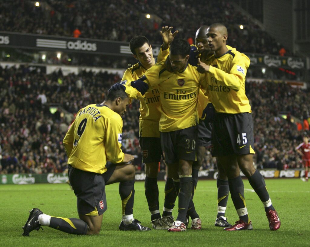 LIVERPOOL, UNITED KINGDOM - JANUARY 09: Julio Baptista of Arsenal shines the boot of team mate Jeremie Aliadiere after scoring his fourth goal and his team's sixth during the Carling Cup quarter final match between Liverpool and Arsenal at Anfield on January 9, 2007 in Liverpool, England. (Photo by Alex Livesey/Getty Images)