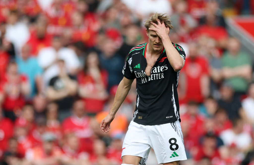 Arsenal comeback at Liverpool overshadowed by red card and injuries 2 LIVERPOOL, ENGLAND - MAY 11: Martin Odegaard of Arsenal, seen with a ripped shirt, reacts during the Premier League match between Liverpool FC and Arsenal FC at Anfield on May 11, 2025 in Liverpool, England. (Photo by Carl Recine/Getty Images)