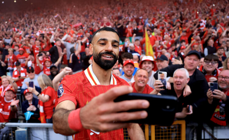 LIVERPOOL, ENGLAND - APRIL 27: Mohamed Salah of Liverpool takes a selfie with the fans, as they celebrate the teams victory and confirmation of win...