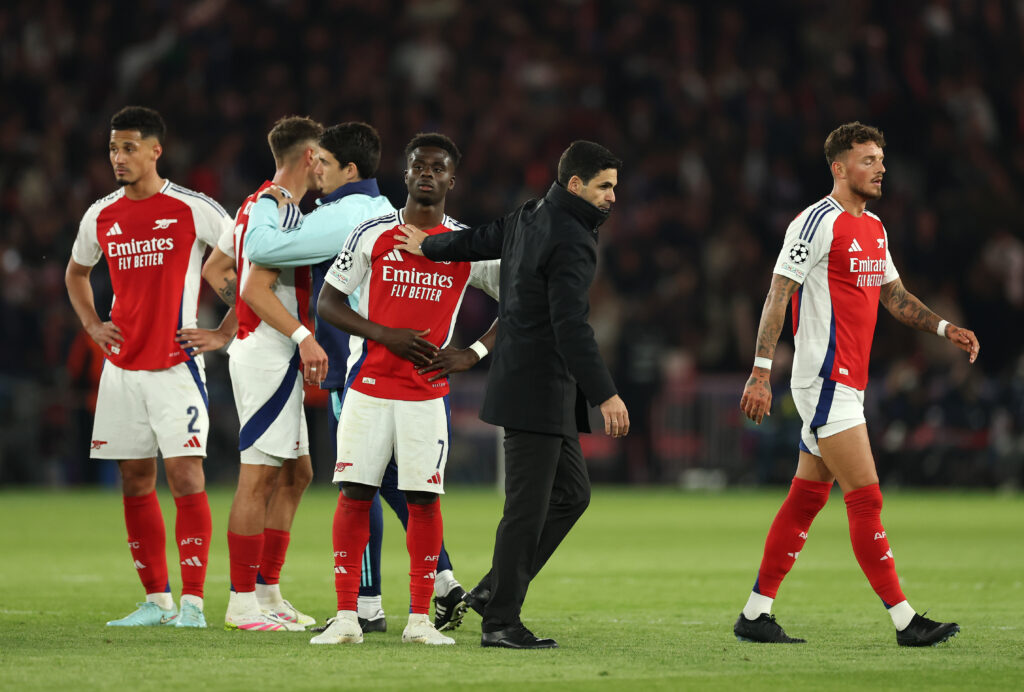 PARIS, FRANCE - MAY 07: Bukayo Saka of Arsenal is consoled by Mikel Arteta, Manager of Arsenal, at full-time following the team's defeat and subsequent elimination after the UEFA Champions League 2024/25 Semi Final Second Leg match between Paris Saint-Germain and Arsenal FC at Parc des Princes on May 07, 2025 in Paris, France. (Photo by Richard Heathcote/Getty Images)
