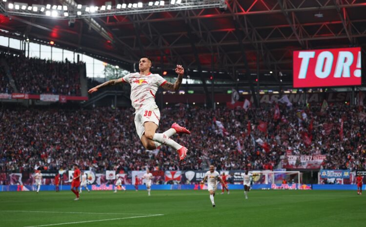 LEIPZIG, GERMANY: Benjamin Sesko of RB Leipzig celebrates scoring his team's first goal during the Bundesliga match between RB Leipzig and FC Bayer...