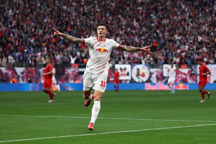 LEIPZIG, GERMANY: Benjamin Sesko of RB Leipzig celebrates scoring his team's first goal during the Bundesliga match between RB Leipzig and FC Bayer...