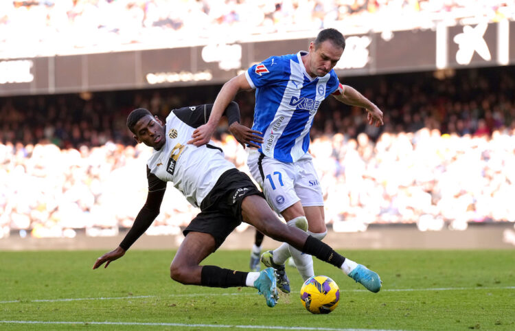 VALENCIA, SPAIN: Cristhian Mosquera of Valencia CF challenges for the ball with Kike of Alaves during the LaLiga match between Valencia CF and Depo...