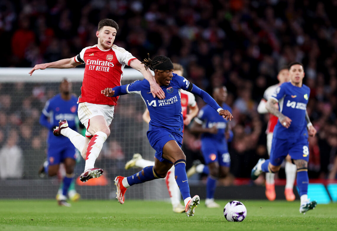 Declan Rice of Arsenal battles for possession with Noni Madueke of Chelsea during the Premier League match between Arsenal FC and Chelsea FC at Emi...