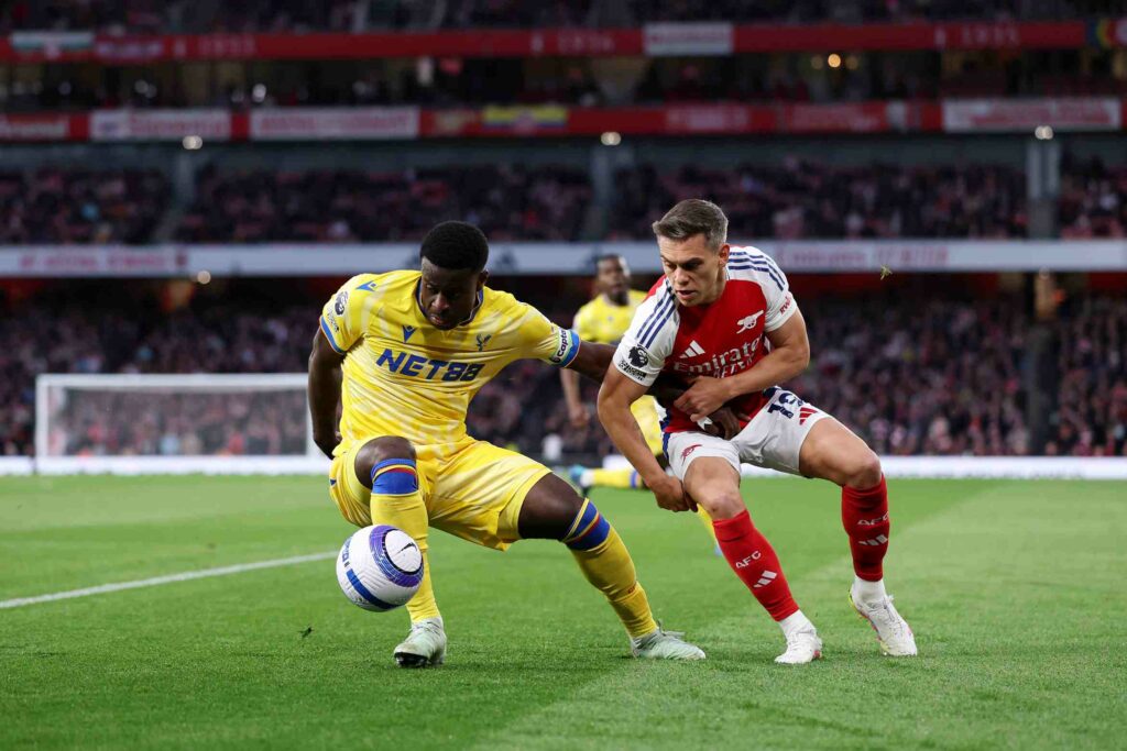 Marc Guehi of Crystal Palace battles for possession with Leandro Trossard of Arsenal during the Premier League match between Arsenal FC and Crystal...