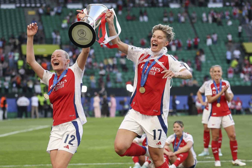 LISBON, PORTUGAL - MAY 24: Amanda Ilestedt and Lina Hurtig of Arsenal celebrate with the UEFA Women's Champions League trophy after defeating FC Barcelona during the UEFA Women's Champions League final match between Arsenal WFC and FC Barcelona at Estadio Jose Alvalade on May 24, 2025 in Lisbon, Portugal. (Photo by Maja Hitij/Getty Images)