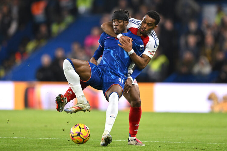 LONDON, ENGLAND - NOVEMBER 10: Noni Madueke of Chelsea is fouled by Jurrien Timber of Arsenal during the Premier League match between Chelsea FC an...