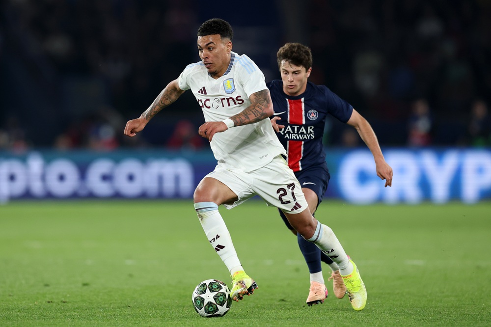 PARIS, FRANCE: Morgan Rogers of Aston Villa runs with the ball whilst under pressure from Joao Neves of Paris Saint-Germain during the UEFA Champions League 2024/25 Quarter Final First Leg match between Paris Saint-Germain and Aston Villa FC at Parc des Princes on April 09, 2025. (Photo by Michael Steele/Getty Images)