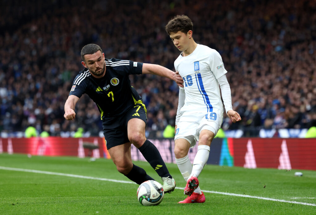 GLASGOW, SCOTLAND - MARCH 23: John McGinn of Scotland battles for possession with Konstantinos Karetsas of Greece during the UEFA Nations League 2024/25 League A/B Play-offs Second Leg match between Scotland and Greece at Hampden Park on March 23, 2025 in Glasgow, Scotland. (Photo by Ian MacNicol/Getty Images)