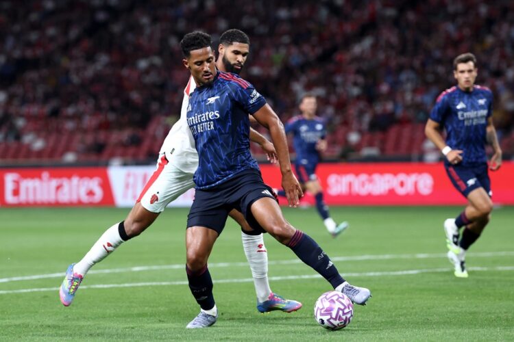 SINGAPORE, SINGAPORE: William Saliba of Arsenal is challenged by Ruben Loftus-Cheek of AC Milan during the Pre-Season Friendly match between Arsena...