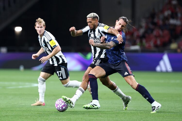 SINGAPORE, SINGAPORE: Joelinton of Newcastle United and Riccardo Calafiori of Arsenal battle for the ball during the Pre-Season Friendly between Ar...