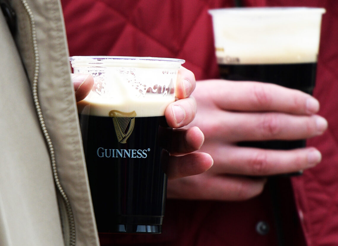 CHELTENHAM, UNITED KINGDOM - MARCH 17: People drink pints of Guinness during Gold Cup Day of the Cheltenham Festival at Cheltenham Racecourse on Ma...