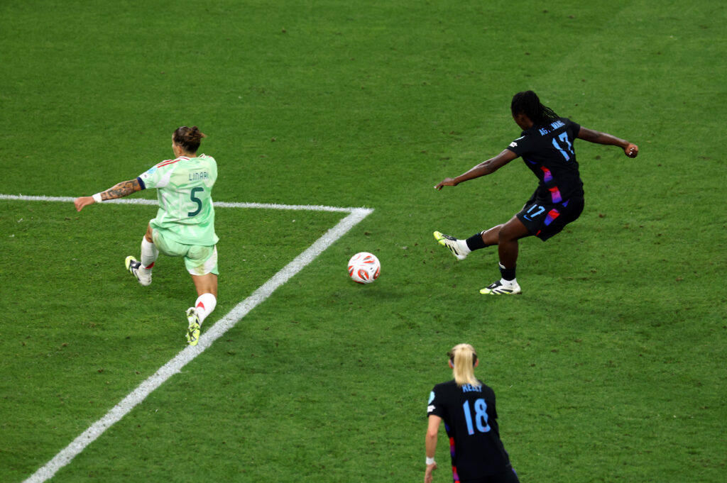 GENEVA, SWITZERLAND - JULY 22: Michelle Agyemang of England scores her team's first goal under pressure from Elena Linari of Italy during the UEFA Women's EURO 2025 Semi-Final match between England and Italy at Stade de Geneve on July 22, 2025 in Geneva, Switzerland. (Photo by Alexander Hassenstein/Getty Images)