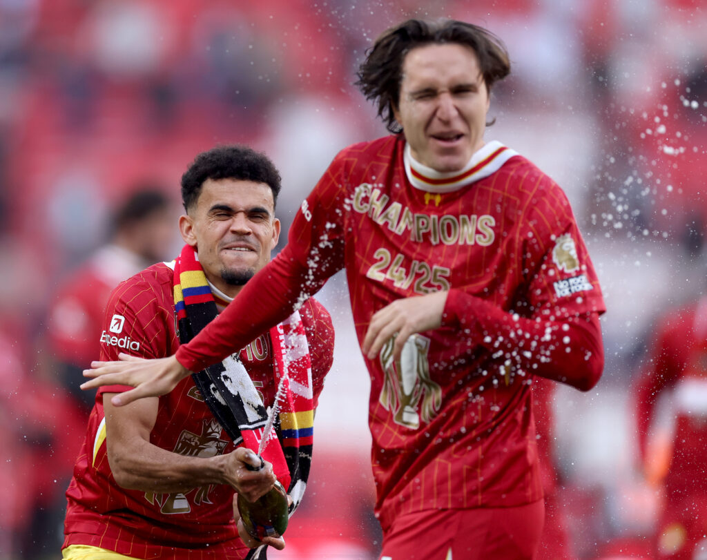 LIVERPOOL, ENGLAND - APRIL 27: Luis Diaz of Liverpool sprays drink over Federico Chiesa of Liverpool, as he celebrates the teams victory and confirmation of winning the Premier League title after the Premier League match between Liverpool FC and Tottenham Hotspur FC at Anfield on April 27, 2025 in Liverpool, England. (Photo by Carl Recine/Getty Images)