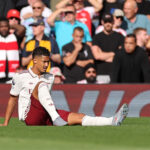 LIVERPOOL, ENGLAND - AUGUST 31: William Saliba of Arsenal reacts with an injury during the Premier League match between Liverpool and Arsenal at Anfield on August 31, 2025 in Liverpool, England. (Photo by Carl Recine/Getty Images)