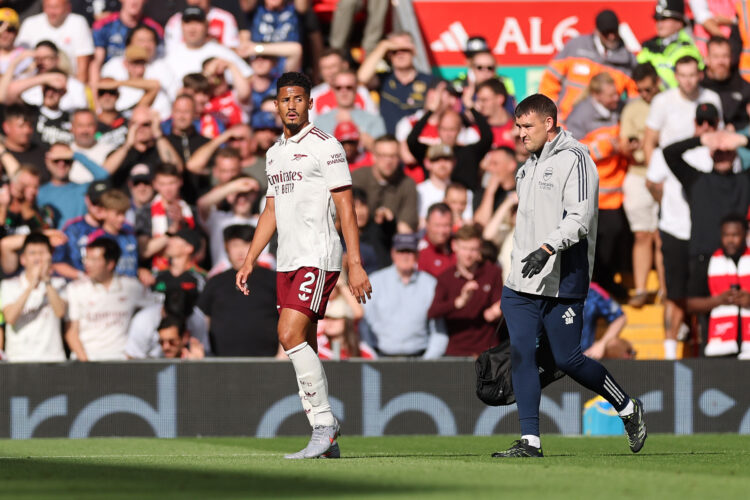 LIVERPOOL, ENGLAND - AUGUST 31: William Saliba of Arsenal leaves the pitch with an injury during the Premier League match between Liverpool and Ars...