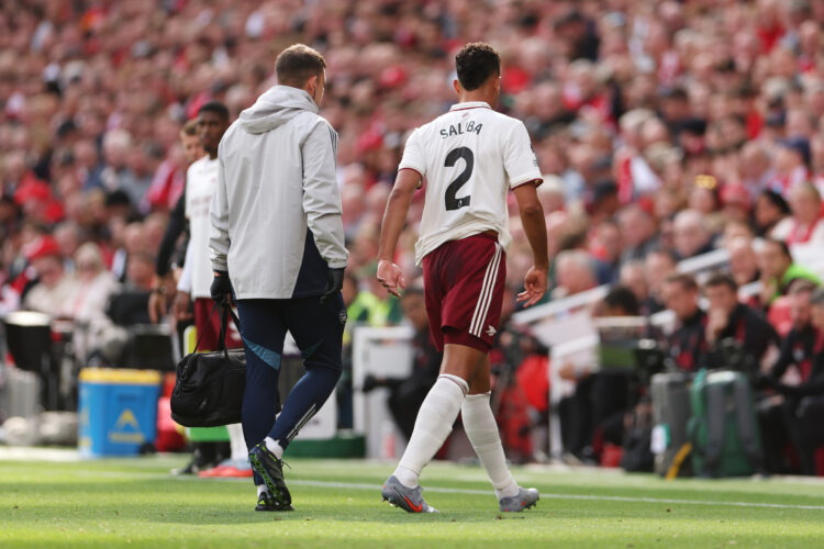 LIVERPOOL, ENGLAND - AUGUST 31: William Saliba of Arsenal leaves the pitch with an injury during the Premier League match between Liverpool and Ars...