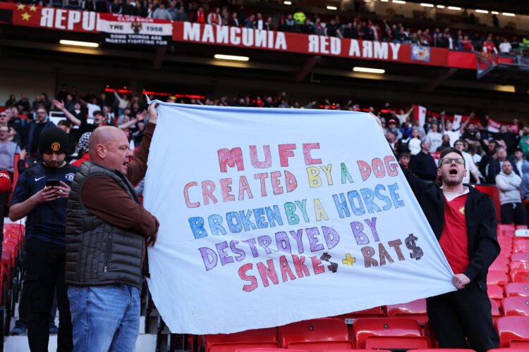MANCHESTER, ENGLAND - APRIL 06: Fans of Manchester United display a banner which reads "MUFC created by a dog, broken by a horse, destroyed by snak...