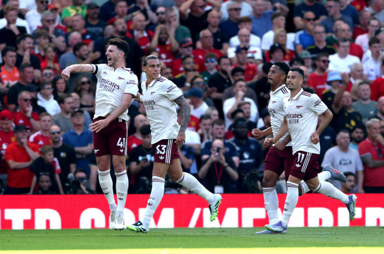MANCHESTER, ENGLAND - AUGUST 17: Declan Rice of Arsenal celebrates after teammate Riccardo Calafiori (2L) scored their team's first goal during the...