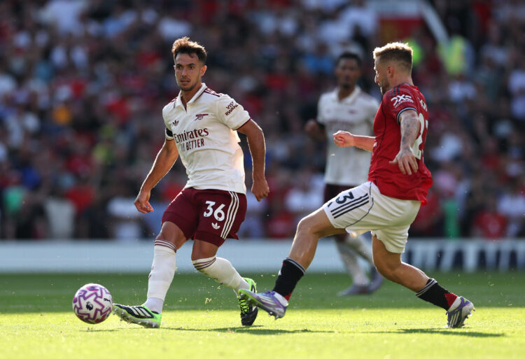 MANCHESTER, ENGLAND - AUGUST 17: Arsenal player Martin Zubimendi beats Luke Shaw to the ball during the Premier League match between Manchester Uni...