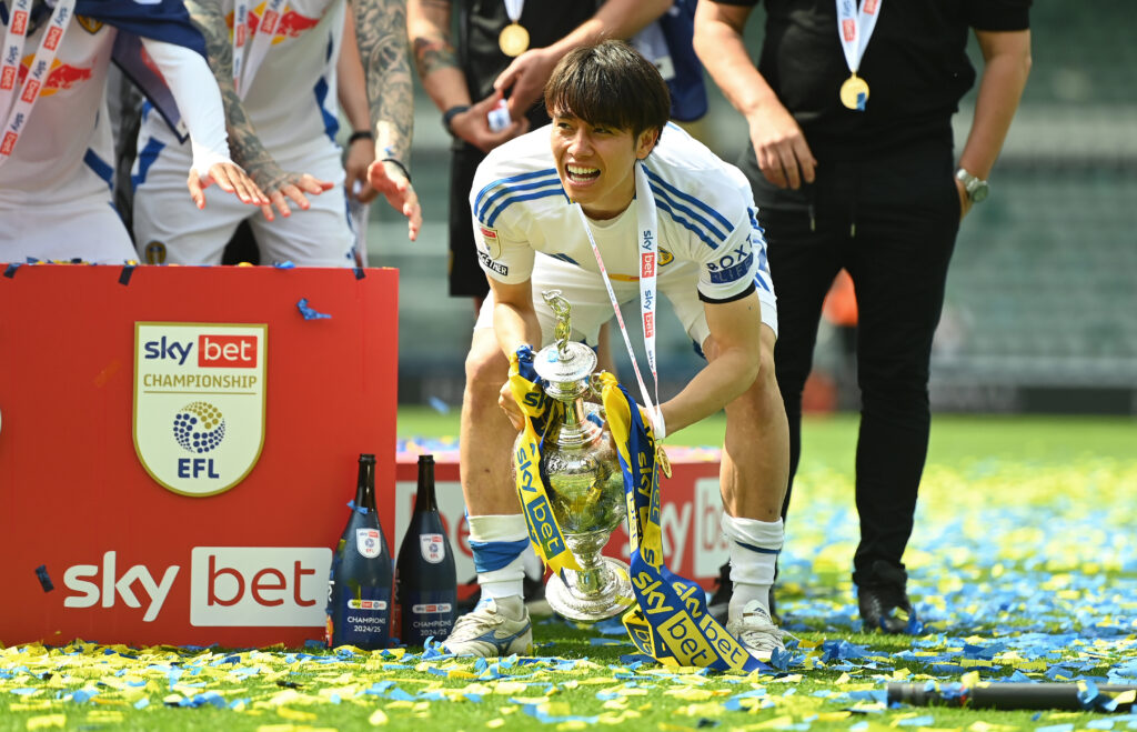 PLYMOUTH, ENGLAND - MAY 03: Ao Tanaka of Leeds United celebrates with the Sky Bet Championship trophy after the teams 2-1 victory, which confirmed that the team has won the Sky Bet Championship and promotion to the Premier League following the Sky Bet Championship match between Plymouth Argyle FC and Leeds United FC at Home Park on May 03, 2025 in Plymouth, England. (Photo by Harry Trump/Getty Images)