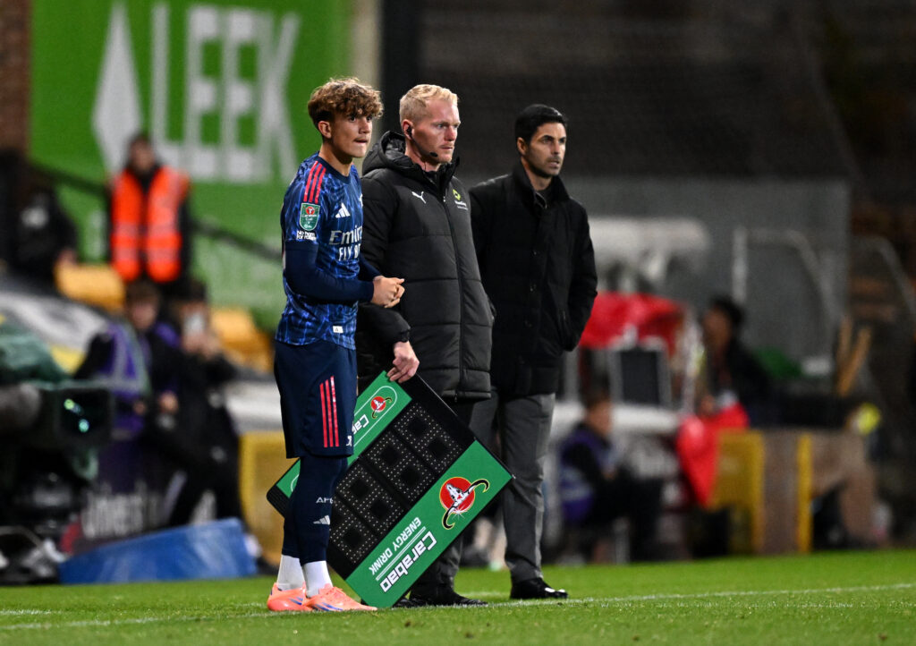 Max Dowman of Arsenal waits on the sidelines before replacing teammate Bukayo Saka (not pictured) as a substitute during the Carabao Cup Third Roun...